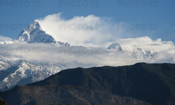 The famous Annapurna massif mountains in the Himalayas covered in clouds, snow and ice in north