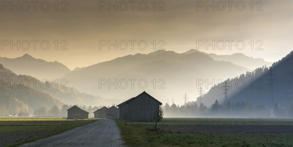 View of the Praettigau Valley near Klosters in Switzerland on an early morning with farm fields and