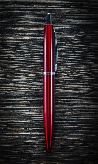 Red biro pen on vintage wooden board