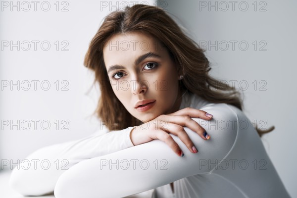 Close up portrait of sensual pretty young woman. Beautiful female model in white cloth with clean
