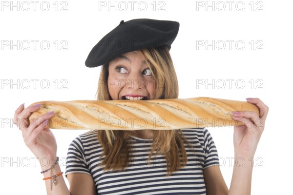 Young French girl with typical French barret and striped shirt eating bread isolated over white