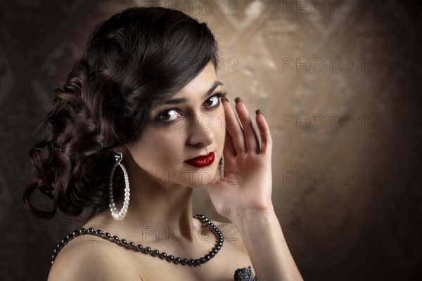 Retro woman portrait. Luxurious lady in the vintage style of the 20s or 30s