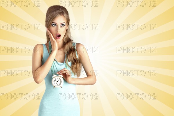 Creative photo of a shocked pin up girl arriving late and holding a retro alarm clock on a