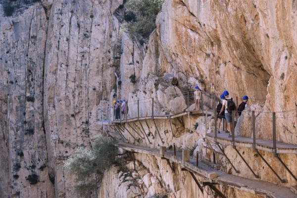 El Chorro, Spain, April 2023: People walking the Caminito Del Rey in the Desfiladero de los