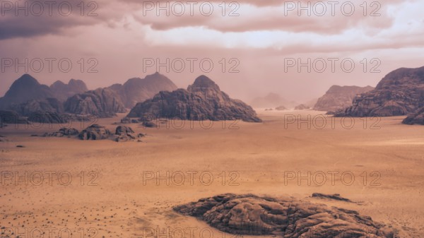 Storm and rain clouds over the desert landscape of Wadi Rum in Jordan. Panoramic shot 16:9 aspect