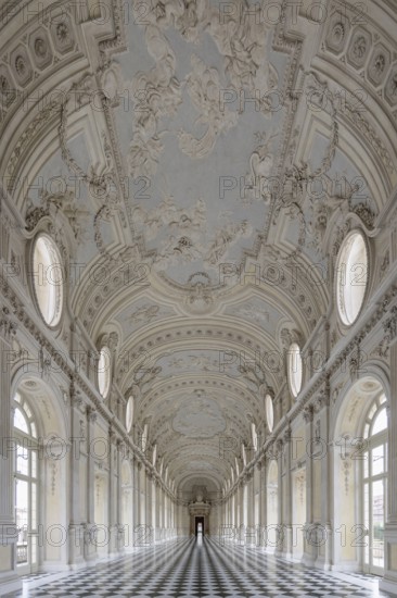 Magnificent, bright baroque corridor with ornately decorated ceiling, Palace of Venaria Reale,