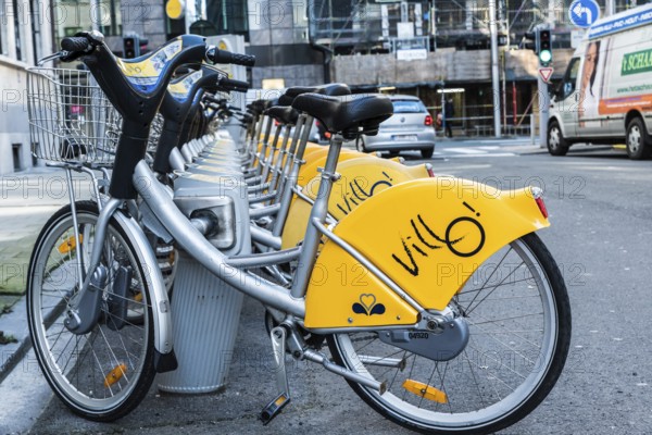 Belgium, 02 15 2019: Villo station with a row of yellow cycles for sharing and renting in the city,