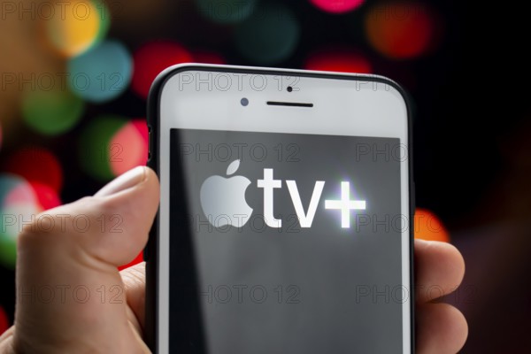 Calgary, Alberta, Canada. May 21, 2020. A person holding a white iPhone Plus with the Apple TV Plus