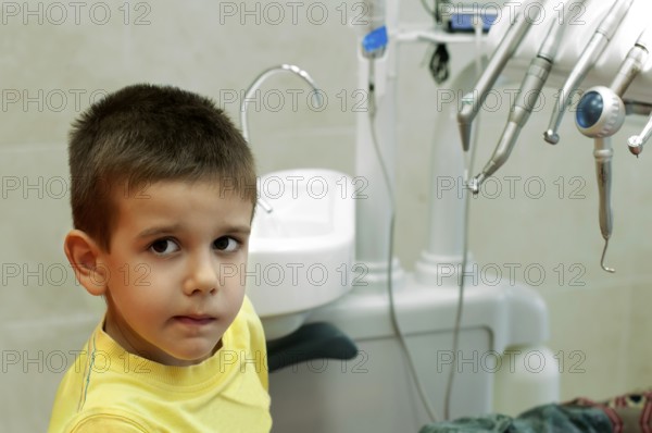 Child in a dentist's chair in cabinet