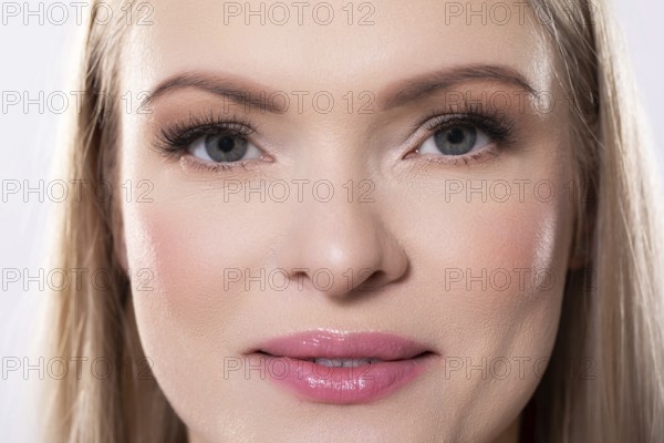 Closeup of an absolutely stunning woman displaying her radiant skin along with her pristine and