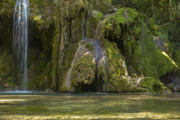 The tufa waterfall near Arbois. Crystal clear waterfall, powerful waterfall