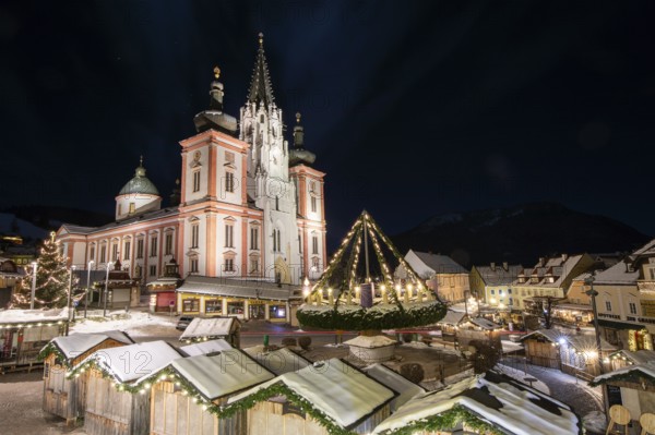 Christmas market in front of the basilica on the main square, night shot, Mariazell, Upper Styria,