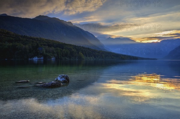 Dramatic sunset above the Bohinj Lake, Slovenia. It is located within the Bohinj Valley of the