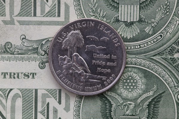 A quarter of U.S. Virgin Islands on US dollar bills. Symmetric composition of US dollar bills and a