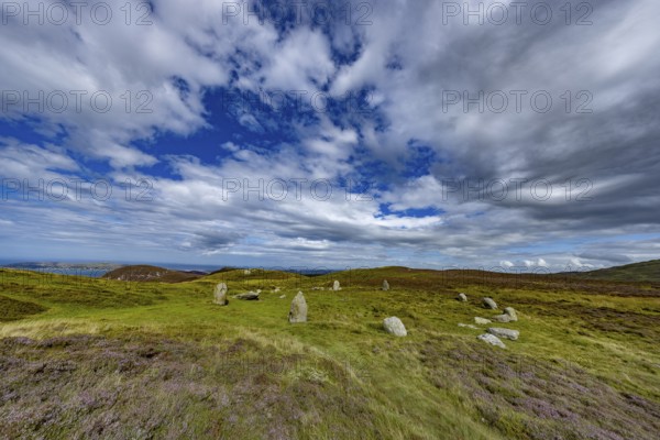 Druids Circle, stone circle in wide landscape with pastures in the mountains, Penmaenmawr,