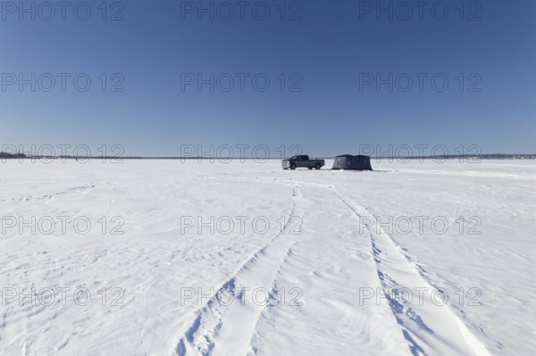 Winter, truck next to a icefishing tent on the frozen Saint Lawrence River, Province of Quebec,