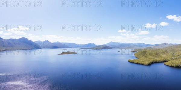 Lake Burbury and surrounding mountain landscape on a warm summer's aftenoon near Queenstown in