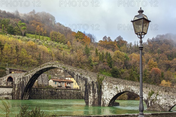 Picturesque stone Devil's Bridge over the Serchio River. Medieval bridge of magnificent