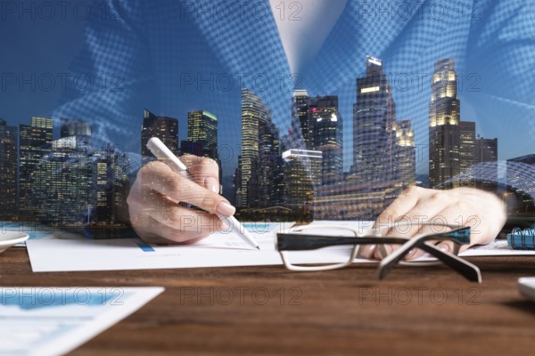 Investment manager analyze financial diagram at wooden desk. Close up woman hand with pen. Strategy