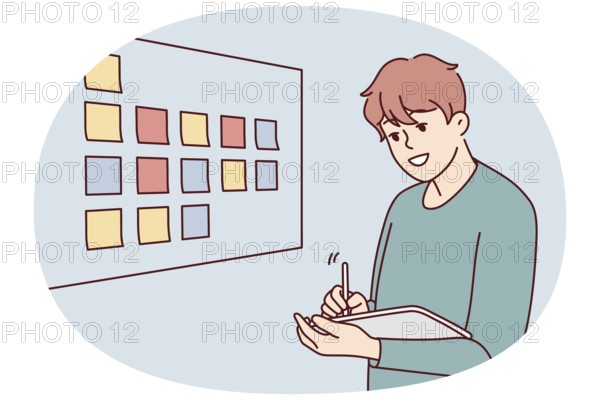 Motivated businessman brainstorm wok with sticky notes on board in office. Male employee or worker