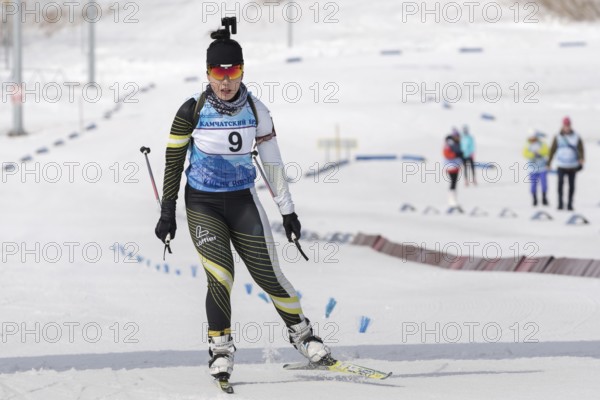 Korean sportswoman biathlete skiing at finish after rifle shooting. Lee Hyunju South Korea during