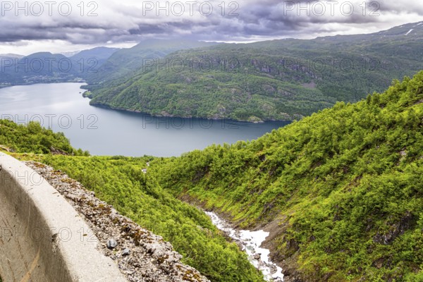 Magnificent panorama of the fjord. Norway. Traveling by camper on road 520. The road is fenced with