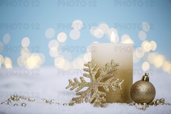 Christmas or new year candle with festive ornaments and bokeh lights on snow, family holidays