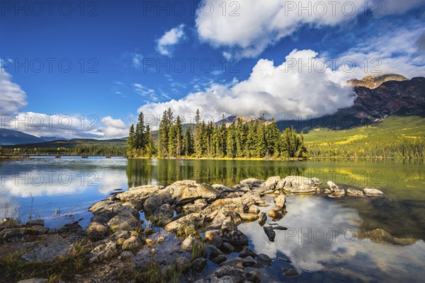 The autumn morning in the Rocky Mountains of Canada. Charming little island in the Pyramid Mountain