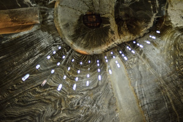 A view of the ceiling in the historic Salina Turda salt mine in Romania called owl's eyes
