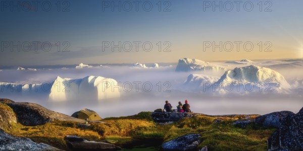 Sitting, picnic, relax by the sea with icebergs in the fog, in the haze