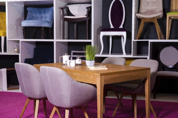 Shop, sale of furniture in a shopping centre. Exposure sample Dining wooden table with textile