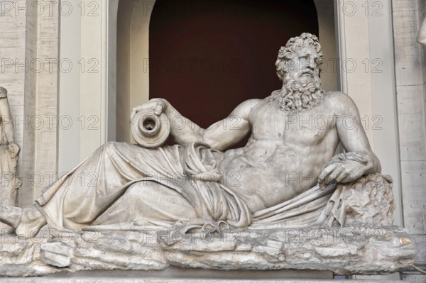 Vatican Museums, Vatican, Rome, Italy, Antique marble sculpture of a bearded man in a relaxed
