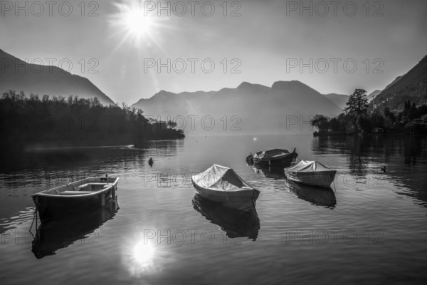 Amazing Lake Como panorama : sunny day in winter, Sheathed boats in water near coast, ducka