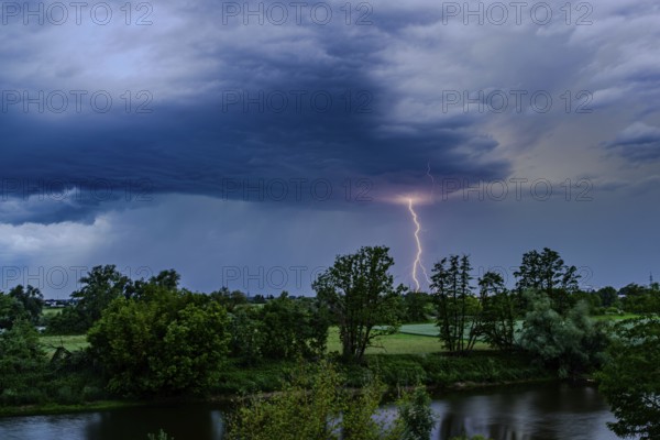 A single bolt of lightning strikes in a dramatic thunderstorm scene with dark clouds, Bogen, Lower