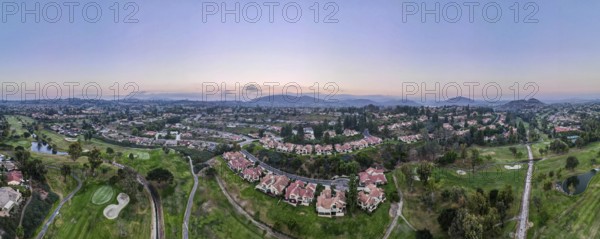 Aerial panoramic view of golf in upscale residential neighborhood during sunset, Rancho Bernardo,