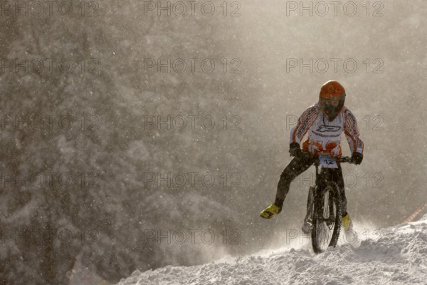 Sofia, Bulgaria - 22 January, 2022: Cyclist rides a bike downhill during an extreme snow riding
