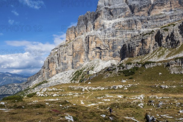 Male mountain climber on a Via Ferrata in breathtaking landscape of Dolomites Mountains in Italy.