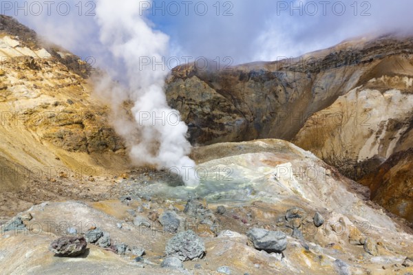 Scenery view of crater of active volcano, amazing volcanic landscape: hot spring and fumarole, lava