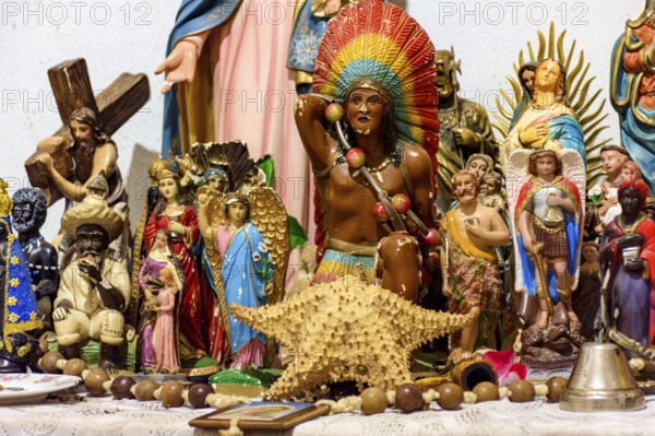 Altar with several images of saints, entities from religions of African origin such as Umbanda and