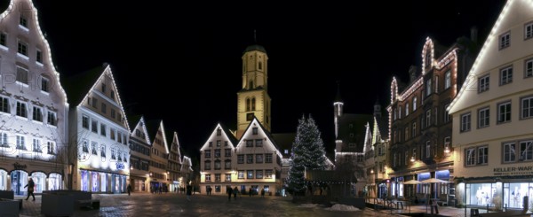 Panoramic night photo of the historic buildings around the market square with Christmas tree and