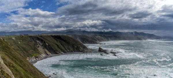 A panorama view of the rugged cliffs and coastline at Cabo Vidio in Asturias under an expressive