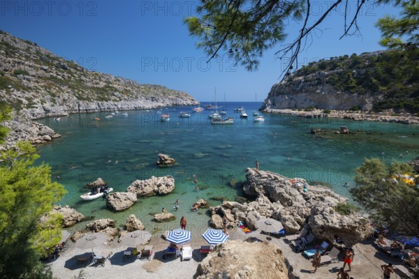 Beach umbrellas and sunbeds, turquoise waters, Anthony Quinn Bay, Faliraki, Rhodes, Dodecanese,