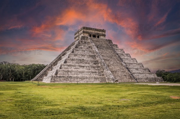 Beautiful clouds at sunrise over the famous Maya pyramid in Yucatan, Mexico that attracts millions