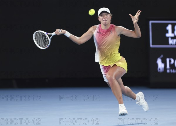 Polish tennis player Iga Swiatek playing a forehand shot at the Australian Open 2025 tournament,