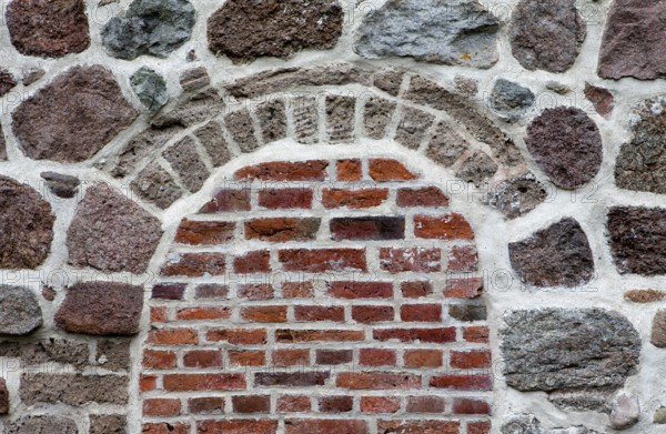 Old stone wall made of erratics rocks and bricks, Church of St. Urbanus, Dorum, Lower Saxony,
