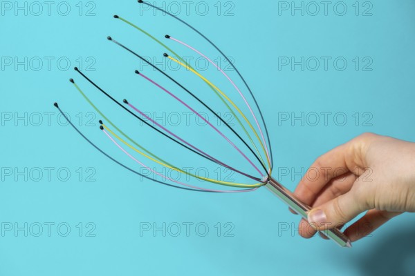 Scalp massager for home. Close up of scalp massaging brush for hair growing routine. Anti stress