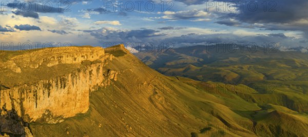 Aerial panorama view of plateau Bermamyt and hills at sunset, North Caucasus mountains, Russia,