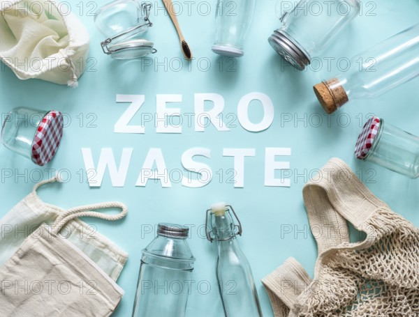 Zero waste concept. Textile eco bags, glass jars and bamboo toothbrush on blue background with Zero