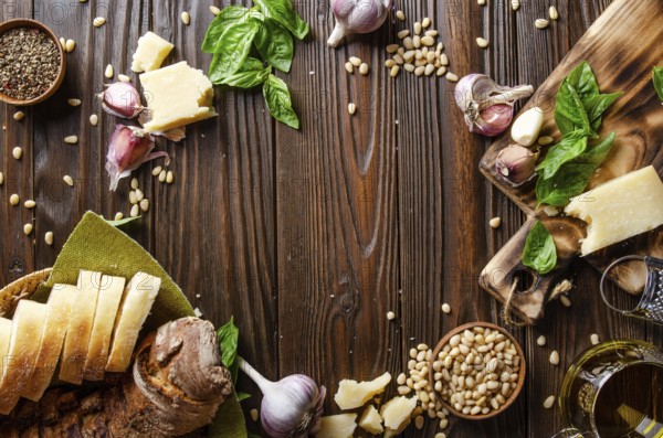 Flat lay view at food background of genovese pesto sauce ingredients on wooden kitchen table with