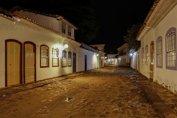 Atmospheric night view of illuminated street and buildings in historical center of Paraty, Brazil,